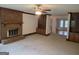 Cozy living room featuring a classic brick fireplace and built-in shelving at 2451 Old Salem Se Cir, Conyers, GA 30013