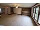 Spacious living room with wet bar, built-in cabinets, and large windows at 2451 Old Salem Se Cir, Conyers, GA 30013