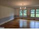 Bright living room featuring hardwood floors, natural light, and an elegant chandelier at 2451 Old Salem Se Cir, Conyers, GA 30013