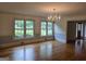 Living room with hardwood floors, three large windows and chandelier at 2451 Old Salem Se Cir, Conyers, GA 30013
