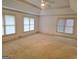 Spacious main bedroom with carpet flooring, tray ceiling, and bright natural light at 2451 Old Salem Se Cir, Conyers, GA 30013