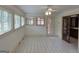 Sunroom with ample windows, neutral tile, and ceiling fan at 2451 Old Salem Se Cir, Conyers, GA 30013
