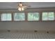 Light-filled sunroom with tiled floors, neutral walls, and a ceiling fan at 2451 Old Salem Se Cir, Conyers, GA 30013