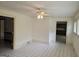Bright sunroom with neutral tile floors and ceiling fan for comfortable living at 2451 Old Salem Se Cir, Conyers, GA 30013
