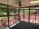 Enclosed sunroom with ceiling fan and outdoor views leading to a spacious deck at 2451 Old Salem Se Cir, Conyers, GA 30013