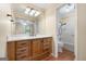 Well-lit bathroom with a vanity featuring a large mirror and wood cabinets, plus a shower-tub combo at 200 Whitney Way, Fayetteville, GA 30214