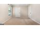 Comfortable bedroom with plush carpeting, ample natural light from a window, and convenient closet access at 200 Whitney Way, Fayetteville, GA 30214