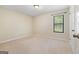 Bright bedroom with neutral carpet and a single window providing natural light, creating a cozy space at 200 Whitney Way, Fayetteville, GA 30214