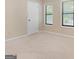 Cozy bedroom featuring neutral carpet, a double window, and a closet, creating a comfortable and functional space at 200 Whitney Way, Fayetteville, GA 30214