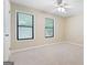 Bright bedroom with neutral walls and carpet, enhanced by natural light streaming through the two large windows at 200 Whitney Way, Fayetteville, GA 30214