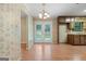 Kitchenette with retro wallpaper, stainless steel appliances, and a breakfast nook area at 200 Whitney Way, Fayetteville, GA 30214