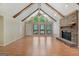 Spacious living room with exposed beams, a cozy fireplace, and large windows for natural light at 200 Whitney Way, Fayetteville, GA 30214