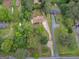 Aerial view of a home with lush greenery, mature trees, and a long driveway at 2609 Lake Harbin Rd, Morrow, GA 30260