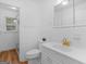 Bathroom with wood floors, white tile, and gold fixtures at 2609 Lake Harbin Rd, Morrow, GA 30260