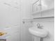 Bright bathroom featuring a pedestal sink and a door with gold hardware at 2609 Lake Harbin Rd, Morrow, GA 30260