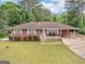 Charming single story brick home with well-manicured lawn and attached carport at 2609 Lake Harbin Rd, Morrow, GA 30260