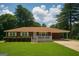 Charming brick home features a well-manicured lawn and covered front porch at 2609 Lake Harbin Rd, Morrow, GA 30260