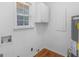 Bright laundry room featuring white walls and a laminate floor at 2609 Lake Harbin Rd, Morrow, GA 30260