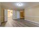 Living room with adjacent kitchen, wood-look floors, and neutral paint at 2986 Parc Lorraine, Lithonia, GA 30038