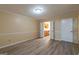 Living room with adjacent kitchen, wood-look floors, and neutral paint at 2986 Parc Lorraine, Lithonia, GA 30038