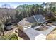 Aerial view of a house with a two-car garage, a big lot, and beautiful surrounding woods at 3133 Callie Still Rd., Lawrenceville, GA 30045