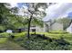 Picture of the house with a large tree in a wooded backyard with a outbuilding at 3133 Callie Still Rd., Lawrenceville, GA 30045