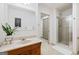 Bright bathroom with a walk-in shower, marble countertop, and decorative mirror at 3133 Callie Still Rd., Lawrenceville, GA 30045