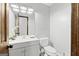 Powder room features a wood door, gray walls, tile floors, a white countertop, and a wood trimmed mirror at 3133 Callie Still Rd., Lawrenceville, GA 30045