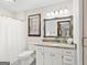 Bathroom features a vanity with granite counters, white cabinets, and a framed mirror at 3133 Callie Still Rd., Lawrenceville, GA 30045
