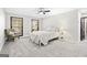 Bright bedroom with neutral carpet, two windows, a chair, and a comfy white bed at 3133 Callie Still Rd., Lawrenceville, GA 30045