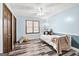 Cozy bedroom featuring light blue walls, dark wood floors and window trim and ceiling fan at 3133 Callie Still Rd., Lawrenceville, GA 30045
