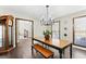 Dining room features a long table with bench, light fixture, and wood floors at 3133 Callie Still Rd., Lawrenceville, GA 30045