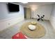 Exercise room with a stationary bike, seating, and tv, ready for a great workout at 3133 Callie Still Rd., Lawrenceville, GA 30045