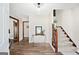 Welcoming home foyer featuring hardwood floors, staircase to second floor, and tasteful decor at 3133 Callie Still Rd., Lawrenceville, GA 30045
