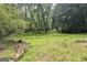 Beautiful grounds with a path, trees, and lush greenery at 3133 Callie Still Rd., Lawrenceville, GA 30045