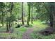 Beautiful grounds with a path, trees, and lush greenery at 3133 Callie Still Rd., Lawrenceville, GA 30045