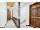 A hallway features a wood railing, a plush carpet, a spindle, and wood doors at 3133 Callie Still Rd., Lawrenceville, GA 30045