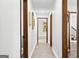 The bright hallway features light colored walls and wood floors at 3133 Callie Still Rd., Lawrenceville, GA 30045