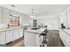 Bright kitchen featuring an island with a gas cooktop, white cabinets, and wood floors at 3133 Callie Still Rd., Lawrenceville, GA 30045