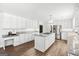 Bright kitchen features granite countertops, an island cooktop, stainless appliances, and hardwood floors at 3133 Callie Still Rd., Lawrenceville, GA 30045