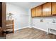 Spacious laundry room features tile floors, wooden cabinetry, a wire rack, and a utility sink at 3133 Callie Still Rd., Lawrenceville, GA 30045