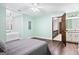 Spacious main bedroom features wood floors, a ceiling fan, a soaking tub, and a ensuite bathroom at 3133 Callie Still Rd., Lawrenceville, GA 30045