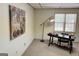 Well-lit home office with a stylish desk, lamp, and a large abstract painting at 3133 Callie Still Rd., Lawrenceville, GA 30045