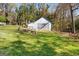 Outbuilding with a roll door, and large green lawn at 3133 Callie Still Rd., Lawrenceville, GA 30045