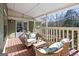 Cozy covered porch featuring wicker seating and tranquil wooded views at 3133 Callie Still Rd., Lawrenceville, GA 30045