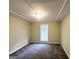 Bedroom with neutral paint, modern ceiling light, and updated carpet flooring at 5219 Maple Valley Sw Rd, Mableton, GA 30126