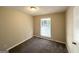 This bedroom features neutral paint, natural light, and updated carpet flooring at 5219 Maple Valley Sw Rd, Mableton, GA 30126