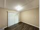 This bedroom features neutral paint, modern sliding door, and updated hardwood flooring at 5219 Maple Valley Sw Rd, Mableton, GA 30126