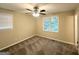 Neutral bedroom with a ceiling fan, carpeted floor and bright natural light coming through a window at 5219 Maple Valley Sw Rd, Mableton, GA 30126