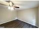 This bedroom features neutral paint, modern ceiling fan, and updated hardwood flooring at 5219 Maple Valley Sw Rd, Mableton, GA 30126